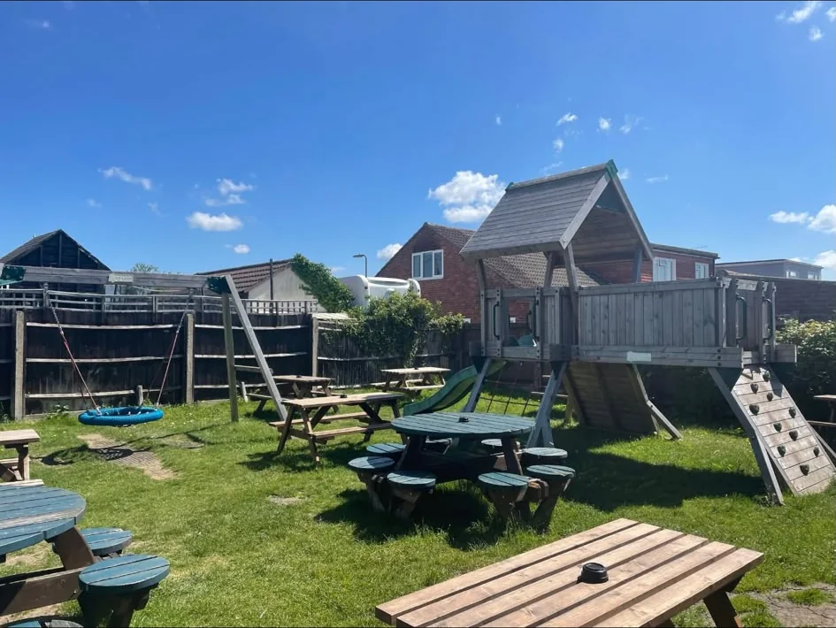 The Falcon garden with picnic tables and children's play area